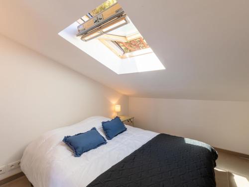 une chambre avec un lit avec deux oreillers bleus dans l'établissement Villa Cantegril by Interhome, à Hyères