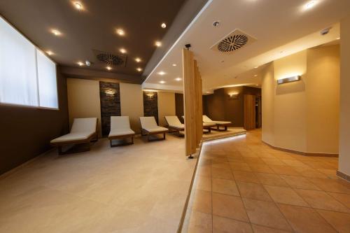 a waiting room at a hospital with white chairs at Hotel Bayerischer Hof Miesbach, BW Premier Collection in Miesbach