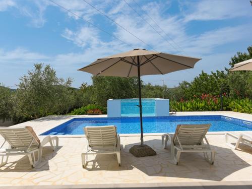 eine Terrasse mit 2 Stühlen und einem Sonnenschirm neben einem Pool in der Unterkunft Holiday Home Anima by Interhome in Galovac