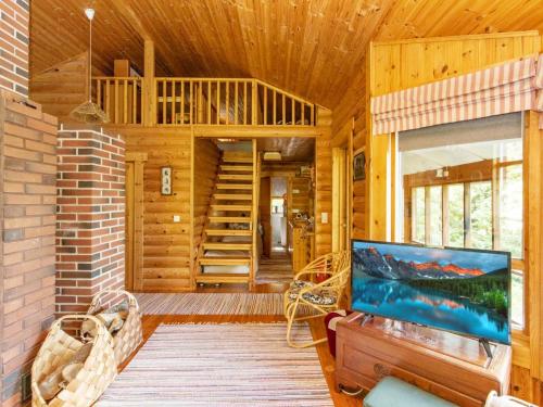 um chalé de madeira com uma escada e uma sala de estar em Holiday Home Jyrkänne by Interhome em Pyöli
