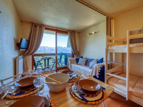 a bedroom with a bunk bed and a living room at Studio Pegase Phenix-73 by Interhome in Le Corbier