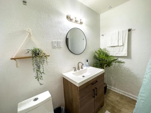 a bathroom with a sink and a mirror and a toilet at Dream Home 10 Min To Beach W Shared Pool #21 in Clearwater