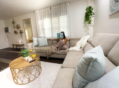 a living room with a woman laying on a couch at Affordable 3br Getaway10 Min To Beach Pool21 in Clearwater