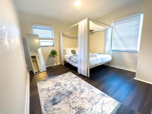 a bedroom with a canopy bed with a mirror at Affordable 3br Getaway10 Min To Beach Pool21 in Clearwater