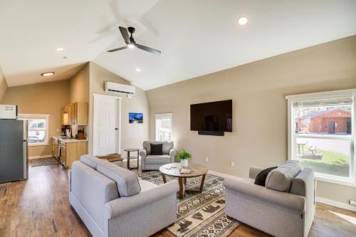 a living room with two chairs and a tv at 20 Mi to Glacier Natl Park Pet-Friendly Cabin in Columbia Falls