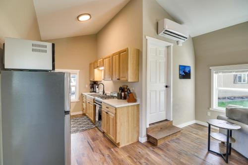 a kitchen with wooden cabinets and a refrigerator at 20 Mi to Glacier Natl Park Pet-Friendly Cabin in Columbia Falls