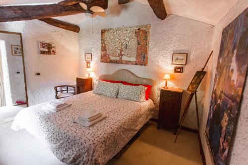 a bedroom with a bed and a painting on the wall at La Torre del Vicario in Palazzuolo sul Senio