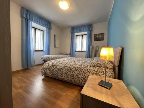 Giường trong phòng chung tại 076 Trilocale, Pinzolo