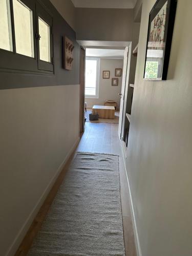 a hallway with a door and a rug at CABADOL - Appartement Aix centre historique - très calme - 50m cours Mirabeau in Aix-en-Provence