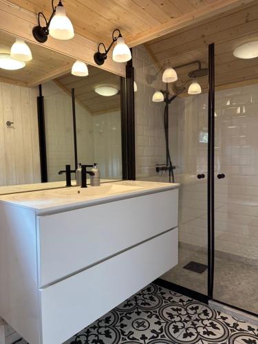 a bathroom with a white sink and a shower at Special cottage in Sirdal in Tjørhom