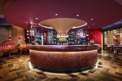 a bar in a restaurant with a purple ceiling at Cairn Hotel Newcastle Jesmond - Part of the Cairn Collection in Newcastle upon Tyne