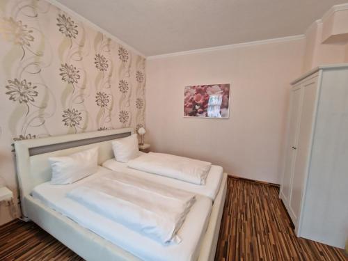 a small room with a bed with white sheets at H5 Hotel Bremen in Bremen