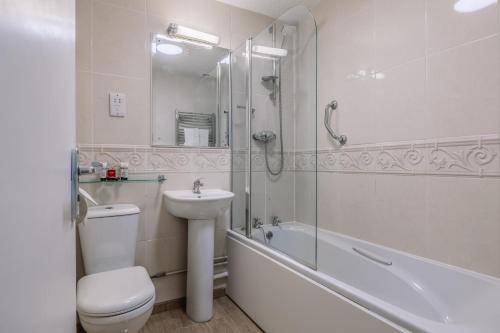 a bathroom with a toilet and a sink and a shower at Muthu Westcliff Hotel (Near London Southend Airport) in Southend-on-Sea