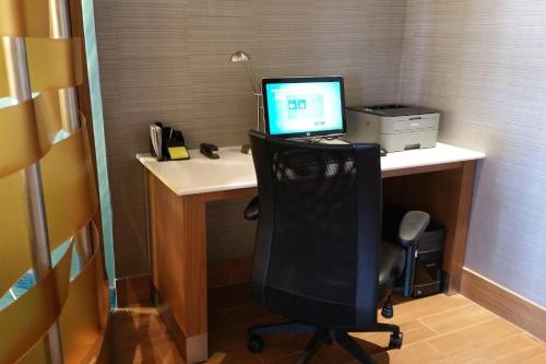 an office with a desk with a computer and a chair at SpringHill Suites West Mifflin in West Mifflin