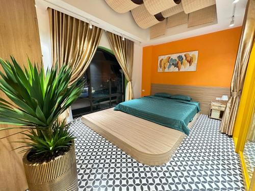 a bedroom with a bed and a potted plant at A4 Home - Ha Long city Central in Ha Long