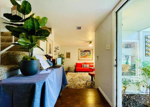 a room with a table with a plant on it at Artists Condo GAME ROOM Patio near UC Med Center in Sacramento