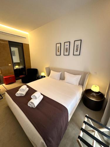 a bedroom with a large bed with two towels on it at Golden Lisbon Hotel in Lisbon