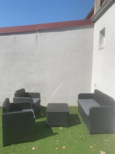 a group of chairs sitting next to a building at L’oasis spa in Quiévrechain