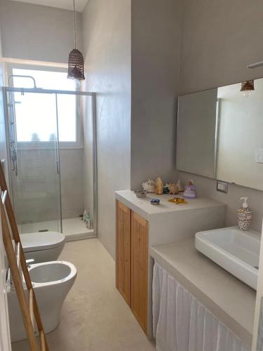 a bathroom with a toilet and a sink and a shower at Paradiso sul mare in Santa Cesarea Terme