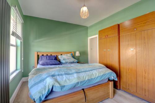 a bedroom with a bed and a green wall at Davis Street in London