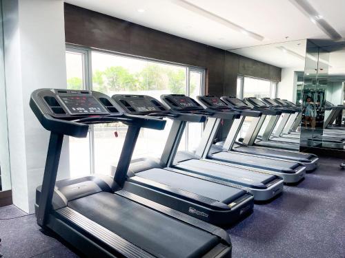 a row of treadmills in a gym at Sunshine 100 Stylish Condo by Homexperience in Manila