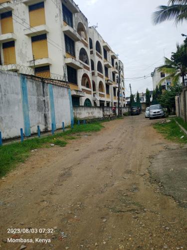 an empty street in front of a building at Urban Residence in Mombasa