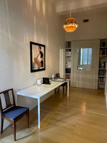 a dining room with a white table and chairs at BB A PARMA DUOMO in Parma