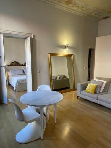 a living room with a table and a couch at BB A PARMA DUOMO in Parma