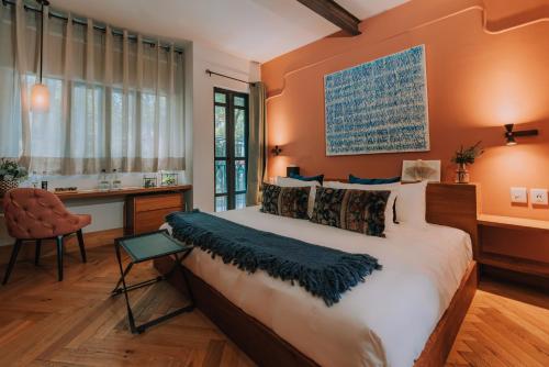 a bedroom with a large bed and a desk at Casa Altata Hotel Boutique in Mexico City