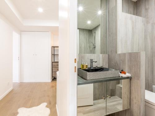 a bathroom with a sink and a mirror at Appartement élégant contemporain avec balcon sud et wifi - FR-1-694-170 in Val dʼIsère