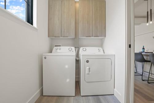 a kitchen with two refrigerators and a washer and dryer at Chic Retreats in Columbus in Columbus