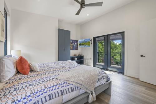 a bedroom with a bed with a ceiling fan at Chic Retreats in Columbus in Columbus