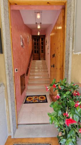 a hallway of a building with stairs and flowers at La casa di Luca in Abbadia San Salvatore