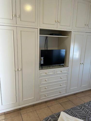 a white cabinet with a tv on top of it at Tulum in San Juan