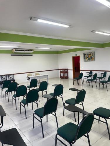 una habitación con sillas y mesas en un aula en Real Palace Hotel, en Três Lagoas