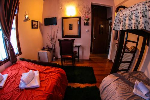a bedroom with a bed and a bunk bed at Mylos in Arkochórion