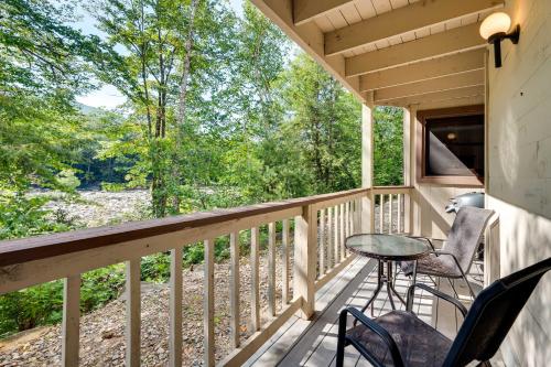 a porch with chairs and a table on it at Riverfront Lincoln Condo with Patio and Pool Access! in Lincoln