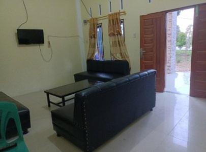 a living room with a couch and a table at Dulcon278 in Sukarami