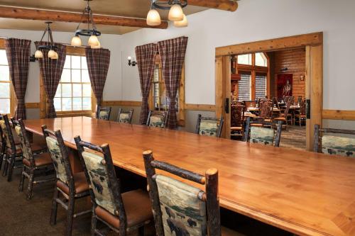 a dining room with a large wooden table and chairs at Hilton Garden Inn Missoula in Missoula