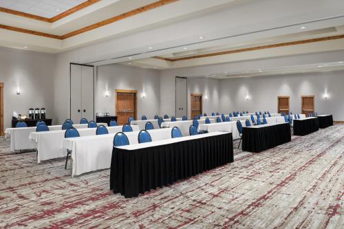 a conference room with tables and chairs and a stage at Hilton Garden Inn Missoula in Missoula
