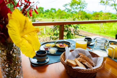 a table with a basket of bread and toast at Galapagos Cabañas Eden in Bellavista