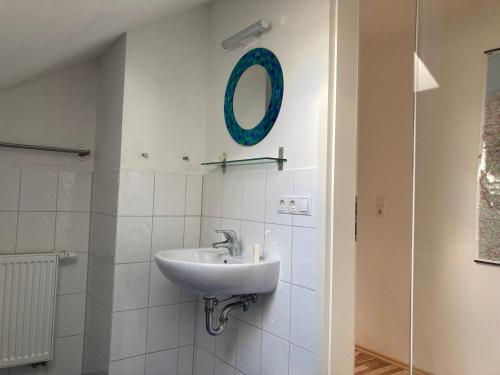 a bathroom with a sink and a mirror on the wall at Ferienwohnung Jeßberger in Bad Königshofen im Grabfeld