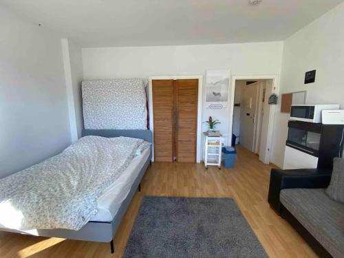 a bedroom with a large bed and a couch at Middle of the city center, with balcony in Hannover