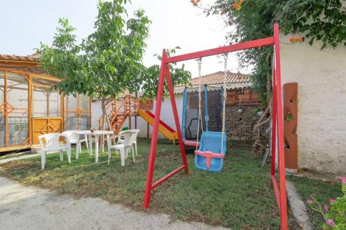 a playground with a table and a swing at Διαμέρισμα με αυλή στη Μέλισσα in Xanthi