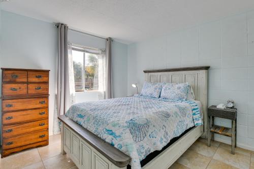 a bedroom with a bed and a dresser and a window at Okaloosa Island Condo Near Boardwalk and Beach! in Fort Walton Beach