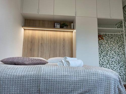 a bedroom with a bed with two towels on it at Studio with a view on City center park in Maribor