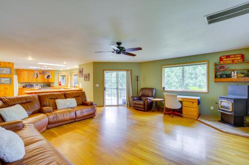a living room with a couch and a table at Hot Tub Riverfront Retreat 4 Mi to Wallace Falls in Sultan
