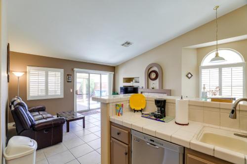 a kitchen with a sink and a living room at North Las Vegas Home about 5 Mi to Fremont St! in Las Vegas