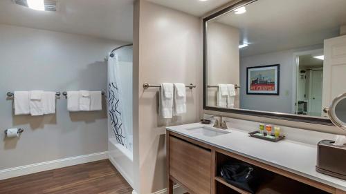 a bathroom with a sink and a large mirror at Bluegreen Vacations Suites at Hershey in Hershey