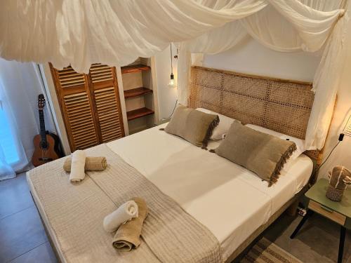 a bedroom with a bed with two towels on it at o'Filao in Grand-Bourg